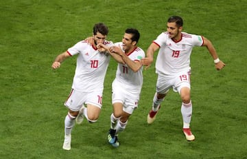 Iran's Karim Ansarifard celebrates with Vahid Amiri and Majid Hosseini