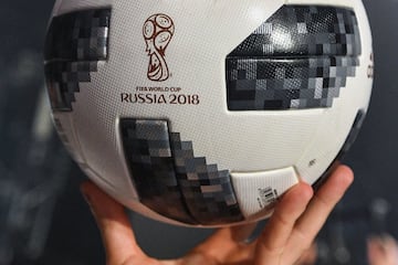 A participant holds the official match ball for the 2018 World Cup football tournament, named "Telstar 18", during its unveiling ceremony in Moscow on November 9, 2017.