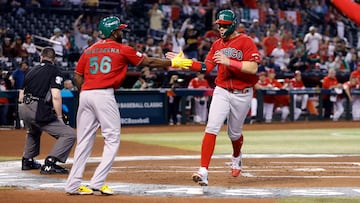 PHOENIX, ARIZONA - MARCH 15: Joey Meneses #32 high fives Randy Arozarena #56 of Team Mexico after scoring against Team Canada during the first inning of the World Baseball Classic Pool C game at Chase Field on March 15, 2023 in Phoenix, Arizona.   Chris Coduto/Getty Images/AFP (Photo by Chris Coduto / GETTY IMAGES NORTH AMERICA / Getty Images via AFP)