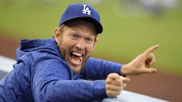 FILE - In this May 25, 2018, file photo, Los Angeles Dodgers pitcher Clayton Kershaw jokes around in the dugout prior to a baseball game against the San Diego Padres in Los Angeles. The photo was part of a series of images by photographer Mark J. Terrill which won the Thomas V. diLustro best portfolio award for 2018 given out by the Associated Press Sports Editors during their annual winter meeting in in Lake Buena Vista, Fla. (AP Photo/Mark J. Terrill, File)