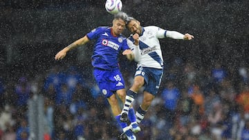 Rodrigo Huescsa (L) of Cruz Azul fights for the ball with Pablo Gonzalez of Puebla during the Mexican Apertura 2023 tournament football match between Cruz Azul and Puebla at the Azteca stadium in Mexico City on November 12, 2023. (Photo by RODRIGO OROPEZA / AFP)