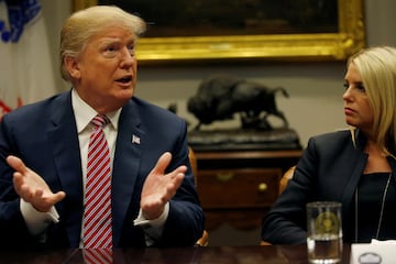 FILE PHOTO: U.S. President Donald Trump makes a point about gun safety in schools while Attorney General Pam Bondi (R-FL) listens during a meeting with local and state officials about improving school safety at the White House in Washington, U.S., February 22, 2018. REUTERS/Leah Millis/File Photo