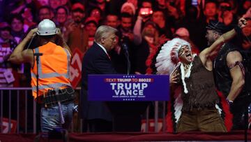 U.S. President-elect Donald Trump stands onstage as the Village People perform during a rally the day before he is scheduled to be inaugurated for a second term, in Washington, U.S., January 19, 2025. REUTERS/Evelyn Hockstein
