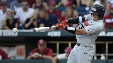 FILE - In this June 28, 2018, file photo, Oregon State's Adley Rutschman hits an RBI single to score Cadyn Grenier during the third inning of Game 3 against Arkansas in the NCAA College World Series baseball finals, in Omaha, Neb. The Baltimore Orioles lead off the Major League Baseball Draft for the first time in 30 years and Oregon State catcher Adley Rutschman is a heavy favorite to be selected No. 1 on Monday night, June 3, 2019. (AP Photo/Nati Harnik, File)
