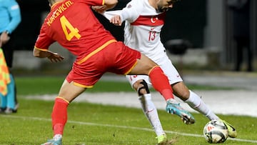 Turkey's defender #13 Eren Elmali (R) fights for the ball with Montenegro's midfielder #04 Marko Vukcevic during the UEFA Nations League League B group 4 football match between Montenegro and Turkey at the City Stadium in Niksic on November 19, 2024. (Photo by SAVO PRELEVIC / AFP)