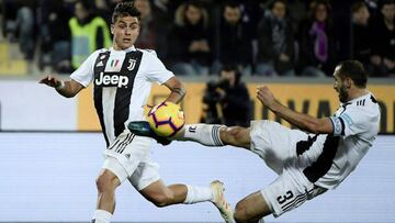 Giorgio Chiellini from Italy (R) scores a goal as Juventus' forward Paulo Dybala from Argentina looks on during the Italian Serie A football match Fiorentina vs Juventus