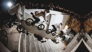 Fernando Laczko tirando un truco de BMX en unas escaleras en plena noche.