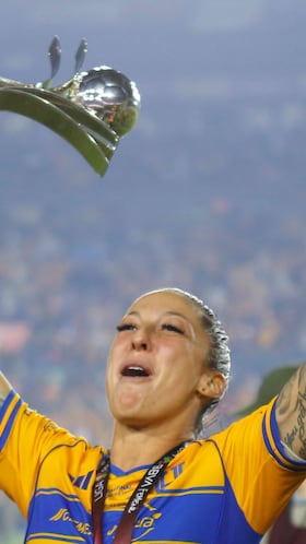 Tigres' midfielder #10 Jennifer Hermoso lifts the trophy after winning the Liga MX Femenil Apertura final second leg football match between Tigres and America at the Universitario Stadium in Monterrey, Nuevo Leon state, Mexico on November 23, 2025. (Photo by Julio Cesar AGUILAR / AFP)