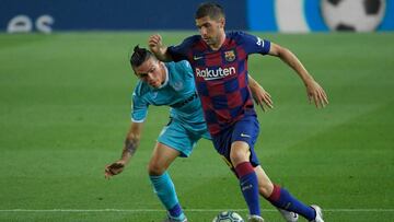 Leganes' Argentinian defender Jonathan Silva (L) challenges Barcelona's Spanish defender Sergi Roberto during the Spanish league football match FC Barcelona against CD Leganes at at the Camp Nou stadium in Barcelona on June 16, 2020. (Photo by L