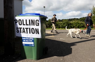 People walk outside a polling station during the general election in Chailey Village, Britain, July 4, 2024.