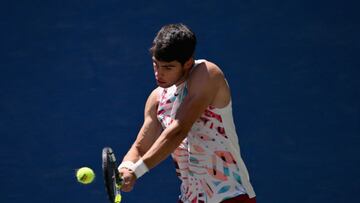 Spain's Carlos Alcaraz hits a return to Britain's Daniel Evans during their US Open tennis tournament men's singles third round match at the USTA Billie Jean King National Tennis Center in New York City, on September 2, 2023. (Photo by ANGELA WEISS / AFP)