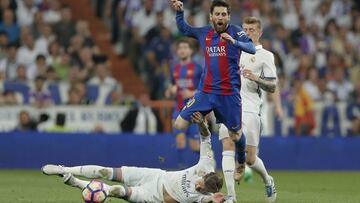 Barcelona's Lionel Messi is fouled by Real Madrid's Sergio Ramos during a Spanish La Liga soccer match between Real Madrid and Barcelona, dubbed 'el clasico', at the Santiago Bernabeu stadium in Madrid, Spain, Sunday, April 23, 2017. (AP Photo/Daniel Ochoa de Olza)