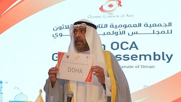 President of the Olympic Council of Asia (OCA) Ahmad al-Fahad al-Sabah holds a placard announcing Doha as the host of the 21st Asian Games 2030 during the 39th OCA General Assembly Meeting in Oman's capital Muscat on December 16, 2020. (Photo by Hait