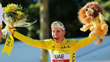 Cycling - Tour de France - Stage 21 - Chatou to Paris Champs-Elysees - France - July 18, 2021 UAE Team Emirates rider Tadej Pogacar of Slovenia celebrates on the podium after winning the yellow jersey and the Tour de France REUTERS/Stephane Mahe