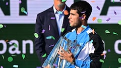 Spain's Carlos Alcaraz poses with the championship trophy after defeating Russia's Daniil Medvedev in the ATP-WTA Indian Wells Masters men's final tennis match at the Indian Wells Tennis Garden in Indian Wells, California, on March 17, 2024. (Photo by Frederic J. BROWN / AFP)