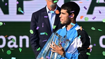 Spain's Carlos Alcaraz poses with the championship trophy after defeating Russia's Daniil Medvedev in the ATP-WTA Indian Wells Masters men's final tennis match at the Indian Wells Tennis Garden in Indian Wells, California, on March 17, 2024. (Photo by Frederic J. BROWN / AFP)