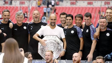 FA Community Shield - Manchester City vs Liverpool
 
 04 August 2019, England, London: Manchester City manager Pep Guardiola (C) and coaching staff pose with the trophy after winning the Community Shield soccer match between Liverpool and Manchester City 