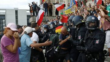 Police officers scuffle with a protester in front of the Reichstag Building during a rally against the government&#039;s restrictions following the coronavirus disease (COVID-19) outbreak, in Berlin, Germany, August 29, 2020. REUTERS/Christian Mang