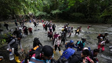 FILE - Migrants, mostly Venezuelans, cross a river during their journey through the Darien Gap from Colombia into Panama, hoping to reach the U.S., Oct. 15, 2022. The United States, Panama and Colombia announced Tuesday, April 11, 2023, that they will launch a 60-day campaign aimed at halting illegal migration through the treacherous Darien Gap, where the flow of migrants has multiplied this year. (AP Photo/Fernando Vergara, File)