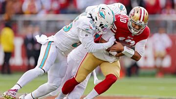 SANTA CLARA, CALIFORNIA - DECEMBER 04: Jaelan Phillips #15 of the Miami Dolphins and Jerome Baker #55 of the Miami Dolphins sack Jimmy Garoppolo #10 of the San Francisco 49ers during the first quarter at Levi's Stadium on December 04, 2022 in Santa Clara, California.   Ezra Shaw/Getty Images/AFP (Photo by EZRA SHAW / GETTY IMAGES NORTH AMERICA / Getty Images via AFP)