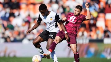 VALENCIA, SPAIN - FEBRUARY 06: Ilaix Moriba of Valencia CF duels for the ball with Cristian Portugues of Real Sociedad during the LaLiga Santander match between Valencia CF and Real Sociedad at Estadio Mestalla on February 06, 2022 in Valencia, Spain. (Ph