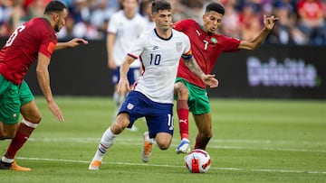 Christian Pulisic dribbles the ball while Morocco midfielder Imran Louza defends during an International friendly soccer match at TQL Stadium.