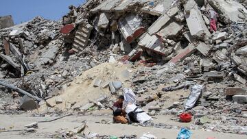 A Palestinian boy sits next to the rubble of a house destroyed by Israeli strikes, amid the ongoing conflict between Israel and Hamas, in the northern Gaza Strip, April 22, 2024. REUTERS/Mahmoud Issa