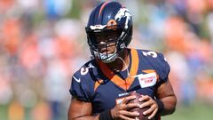 Quarterback Russell Wilson of the Denver Broncos practices with his team during training camp at UCHealth Training Center on July 27, 2022 in Englewood, Colorado.