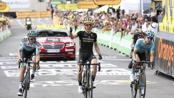 BAGNERES-DE-BIGORRE, FRANCE - JULY 18: Simon Yates of Great Britain and Mitchelton-Scott celebrates winning in front of Peleo Bilbao Lopez De Armentia of Spain and Astana Pro Team (right) and Gregor Muhlberger of Austria and Bora-Hansgrohe (left) during s