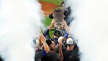Oct 31, 2024; New York, New York, USA; The Los Angeles Dodgers celebrates with the Commissioner's Trophy after beating the New York Yankees in game four to win the 2024 MLB World Series at Yankee Stadium. Mandatory Credit: Robert Deutsch-Imagn Images