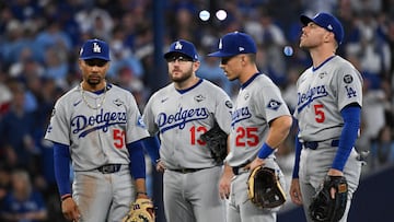 Oct 24, 2025; Toronto, Ontario, CAN; Los Angeles Dodgers shortstop Mookie Betts (50), third baseman Max Muncy (13), second baseman Tommy Edman (25) and first baseman Freddie Freeman (5) look on during a pitching change against the Toronto Blue Jays in the sixth inning during game one of the 2025 MLB World Series at Rogers Centre. Mandatory Credit: Dan Hamilton-Imagn Images