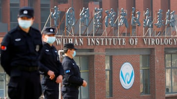 FILE PHOTO: Security personnel keep watch outside Wuhan Institute of Virology during the visit by the World Health Organization (WHO) team tasked with investigating the origins of the coronavirus disease (COVID-19), in Wuhan, Hubei province, China February 3, 2021. REUTERS/Thomas Peter/File Photo