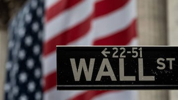 (FILES) In this file photo taken on April 30, 2020, the US flag is seen at the New York Stock Exchange (NYSE) in New York City. - Despite moves to reopen businesses, another 1.54 million US workers filed for unemployment benefits last week, the Labor Depa