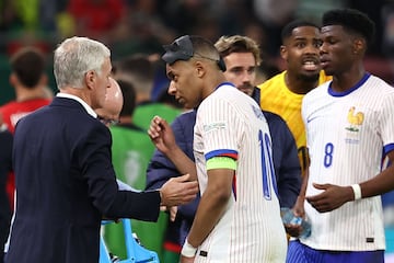 Captain Mbappé speaks with head coach Deschamps during the UEFA Euro 2024 quarter-final against Portugal.