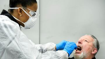 FILE PHOTO: A member of medical staff takes a coronavirus test sample of a man in Bergschenhoek, Netherlands January 13, 2021. REUTERS/Piroschka van de Wouw/File Photo