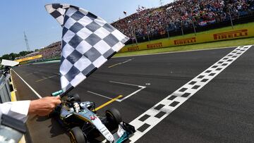 (FILES) Mercedes AMG Petronas F1 Team's British driver Lewis Hamilton crosses the finish line to win the Formula One Hungarian Grand Prix at the Hungaroring circuit in Mogyorod near Budapest, Hungary, on July 24, 2016. Seven-time Formula One world champion Lewis Hamilton will leave Mercedes at the end of the 2024 season, the team announced February 1, 2024, ahead of an expected move to Ferrari. "Lewis has activated a release option in the contract announced last August and this season will therefore be his last driving for the Silver Arrows," Mercedes said in a statement. (Photo by ANDREJ ISAKOVIC / POOL / AFP)