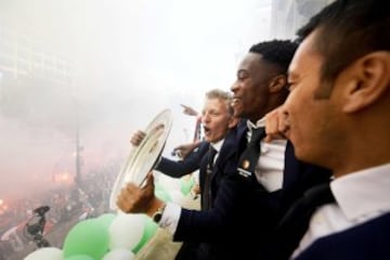 Feyernoord's Dirk Kuyt, team mates and coach Giovanni van Bronckhorst celebrate the club's 15th league win on the town hall balcony in Rotterdam.