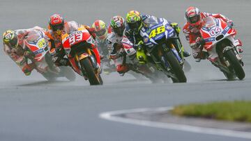(L-R) Honda rider Marc Marquez of Spain, Yamaha rider Valentino Rossi of Italy an Ducati rider Andrea Dovizioso of Italy lead the pack during the MotoGP race of the Grand Prix of Germany at the Sachsenring Circuit on July 17, 2016 in Hohenstein-Ernstthal, eastern Germany.
  / AFP PHOTO / Robert MICHAEL