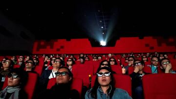 FILE PHOTO: People watch a movie at a cinema in Wanda Group's Oriental Movie Metropolis ahead of its opening, in Qingdao, Shandong province, China April 27, 2018. REUTERS/Aly Song/File Photo