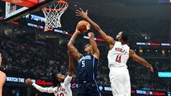 Paolo Banchero #5 of the Orlando Magic shoots over Darius Garland #10 and Evan Mobley #4 of the Cleveland Cavaliers during the first quarter of game one of the Eastern Conference First Round Playoffs at Rocket Mortgage Fieldhouse on April 20, 2024 in Cleveland, Ohio.