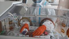 A medical specialist wearing personal protective equipment (PPE) takes care of a newborn baby at the maternity ward of the City Clinical Hospital Number 15 named after O. Filatov, amid the outbreak of the coronavirus disease (COVID-19) in Moscow, Russia, 