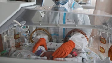 A medical specialist wearing personal protective equipment (PPE) takes care of a newborn baby at the maternity ward of the City Clinical Hospital Number 15 named after O. Filatov, amid the outbreak of the coronavirus disease (COVID-19) in Moscow, Russia, 