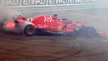 Ferrari&#039;s German driver Sebastian Vettel drifts with his car after the Abu Dhabi Formula One Grand Prix at the Yas Marina circuit on November 25, 2018, in Abu Dhabi. (Photo by Andrej ISAKOVIC / AFP)