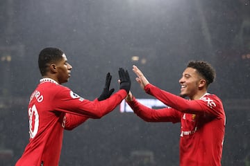 Manchester United's English striker Marcus Rashford (L) celebrates with Manchester United's English striker Jadon Sancho (R) after scoring his team first goal during the English Premier League football match between Manchester United and Brentford at Old Trafford in Manchester, north west England, on April 5, 2023. (Photo by Darren Staples / AFP) / RESTRICTED TO EDITORIAL USE. No use with unauthorized audio, video, data, fixture lists, club/league logos or 'live' services. Online in-match use limited to 120 images. An additional 40 images may be used in extra time. No video emulation. Social media in-match use limited to 120 images. An additional 40 images may be used in extra time. No use in betting publications, games or single club/league/player publications. / 