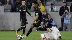 Los Angeles FC&#039;s Carlos Vela, center, leaps over Real Salt Lake&#039;s Kyle Beckerman during the second half of an MLS soccer match Saturday, March 23, 2019, in Los Angeles. (AP Photo/Marcio Jose Sanchez)