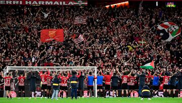 Athletic Bilbao players celebrate their win with fans on the stands at the end of the Spanish league football match between Athletic Club Bilbao and Club Atletico de Madrid at the San Mames stadium in Bilbao on December 16, 2023. (Photo by ANDER GILLENEA / AFP)