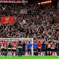 Athletic Bilbao players celebrate their win with fans on the stands at the end of the Spanish league football match between Athletic Club Bilbao and Club Atletico de Madrid at the San Mames stadium in Bilbao on December 16, 2023. (Photo by ANDER GILLENEA / AFP)