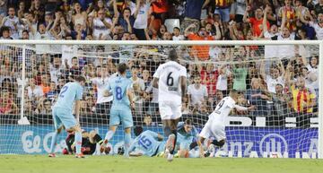 In demand | Rodrigo scores for Valencia in their 1-1 opening day draw with Atlético.