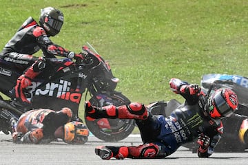 Monster Energy Yamaha MotoGP's French rider Fabio Quartararo (R) and Red Bull KTM Factory's Australian rider Jack Miller (2L) fall after a collision during the MotoGP Malaysian Grand Prix at the Sepang International Circuit in Sepang on November 3, 2024. (Photo by MOHD RASFAN / AFP)