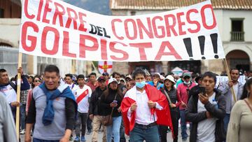 Demonstrators carry a sign reading "Closure of the coup Congress," amid violent protests following the ousting and arrest of former President Pedro Castillo, in Ayacucho, Peru.